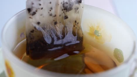 close up of a tea bag steeping in a cup of tea