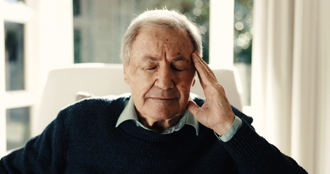 Elderly Man Suffering From a Headache at Home