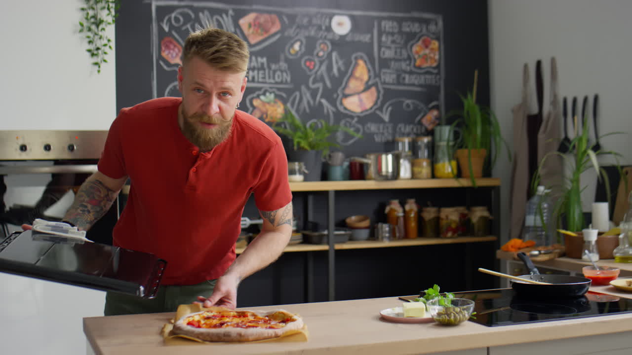 Chef Putting Just Baked Pizza on Kitchen Table