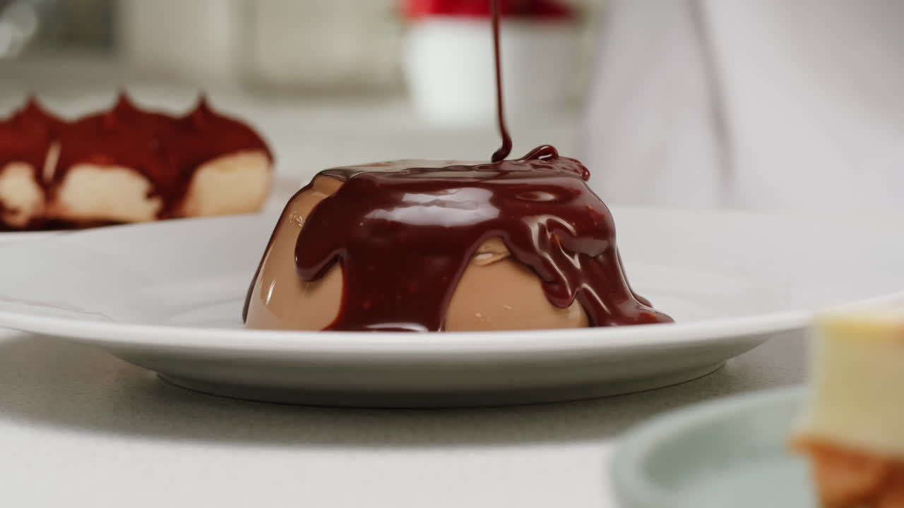 Pouring Chocolate Sauce Over Panna Cotta