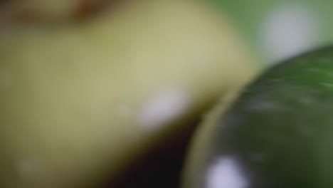 rotation of a fresh green and yellow apples for a healthy diet - closeup shot