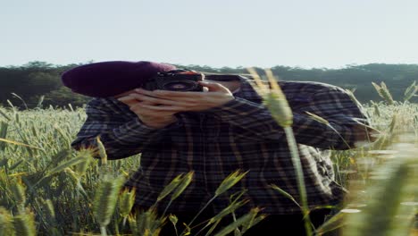 man taking photo in a wheat field