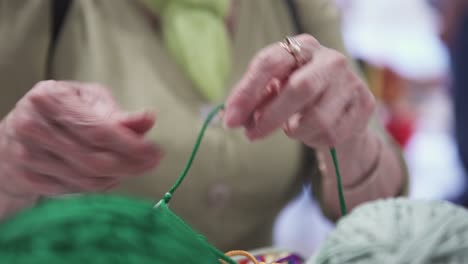 woman knitting with colorful yarns