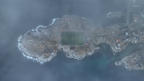 Stream-weather-Aerial-view-of-Henningsvaer-football-field-on-Lofoten-Islands,-Norway