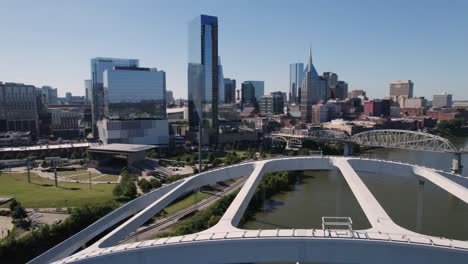 aerial downtown nashville over bridge and cumberland river with city and buildings in background