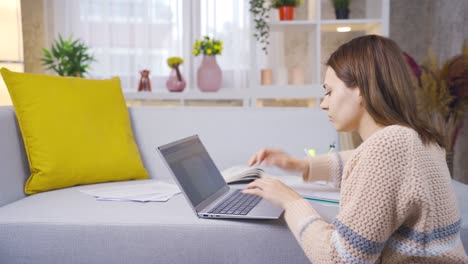 Young-college-student-girl-learning-and-learning-remotely-online-using-laptop.