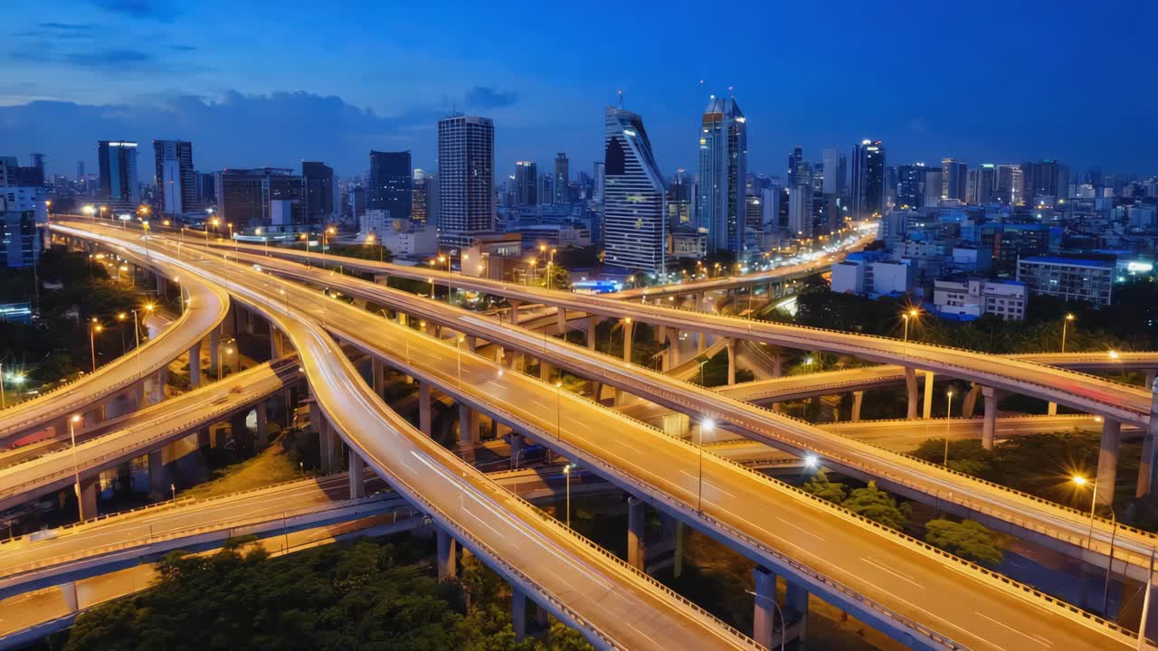Complex Highway Interchange and Cityscape at Night