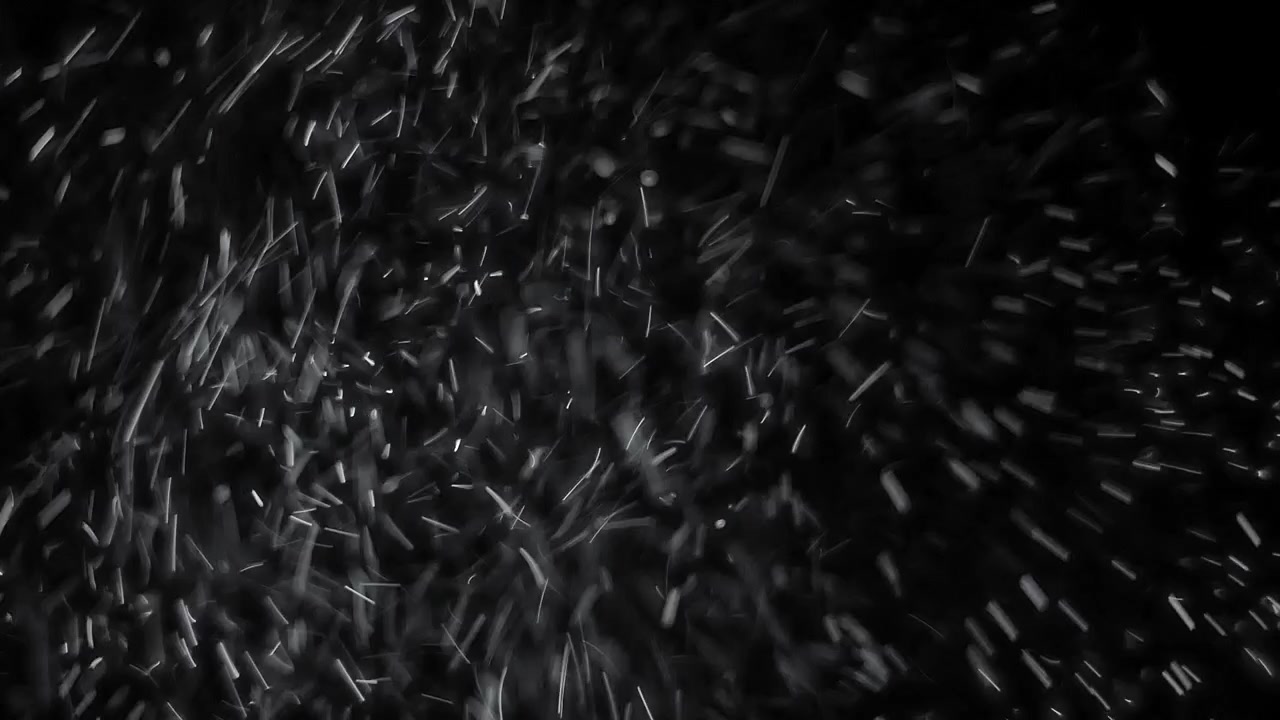 Floating White Dust Particles Against a Black Background