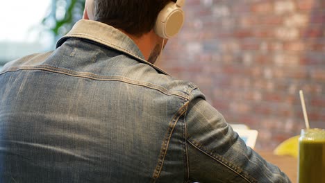 man listening to music on digital tablet