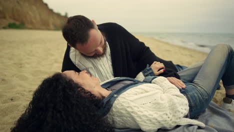 couple enjoying romantic date at beach. joyful people flirting together by sea.