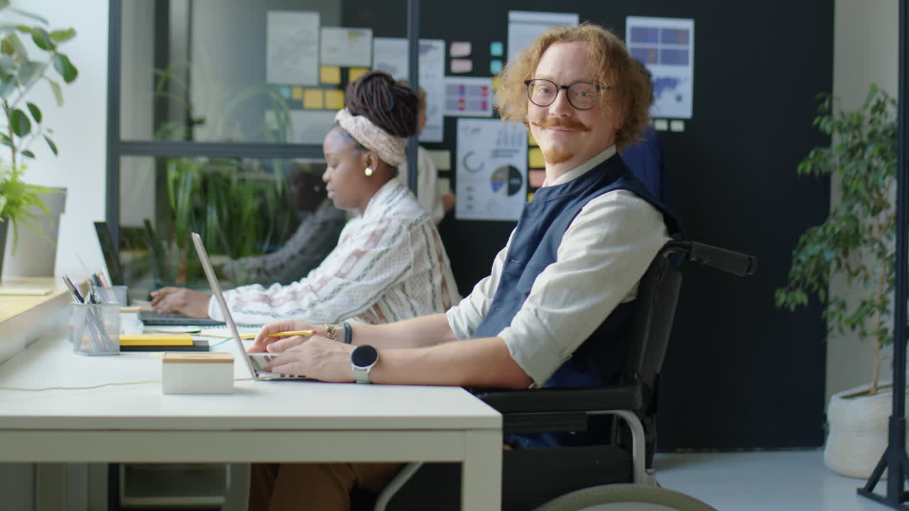 Portrait of Man in Wheelchair at Office Workplace