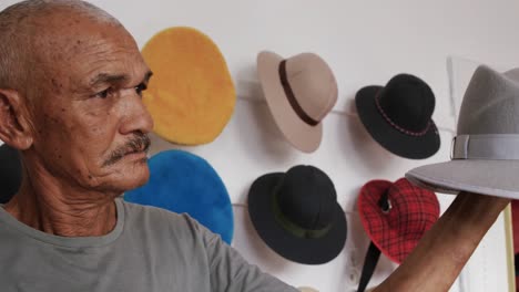 mixed race man working at a hat factory