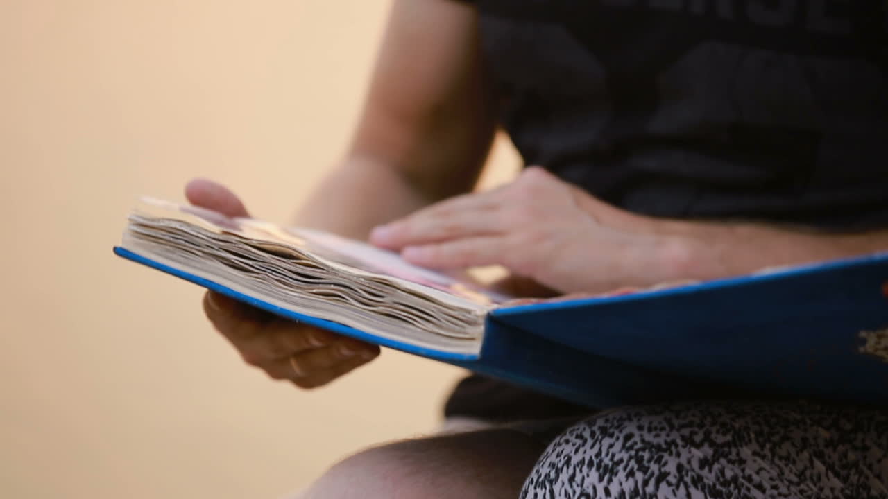 Holding Photo Album With Pictures. Hands holding photo album with picture in nature