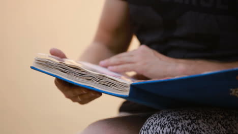 holding photo album with pictures. hands holding photo album with picture in nature