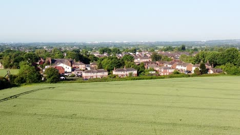 Aerial-drone-shot-of-cronton-village-in-united-kingdom-overlooking-the-farmland-with-residential-houses-and-beautiful-landscape