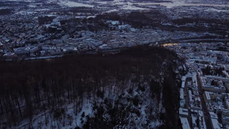 Wonderful-aerial-reveal-tilt-up-of-Salzburg-city-covered-with-snow-in-winter