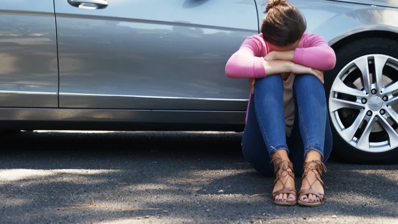 차 근처 에 앉아 있는 우울 한 여자