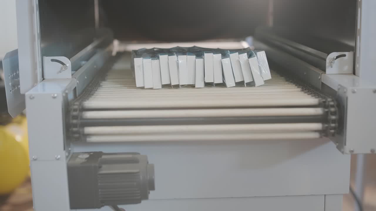 Packages on a conveyor belt in a manufacturing plant