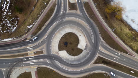 aerial: timelapse of roundabout with motor vehicles entering and exiting it