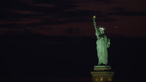 statue of liberty at night with lights on