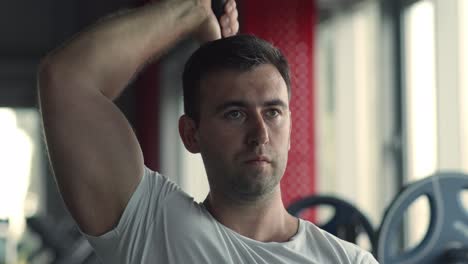 man lifting weights in gym