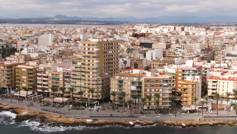 coastal cityscape of torrevieja city in spain, aerial fly forward view