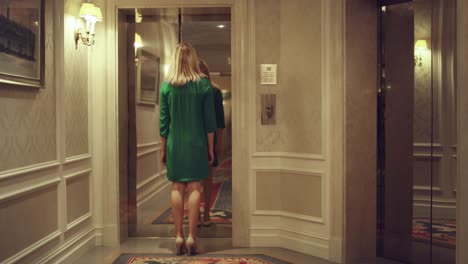 young woman coming into elevator car and lift doors closing