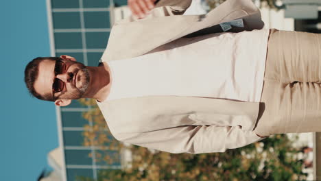 man in a beige suit outdoors