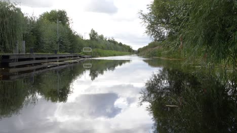 Calm-Water-Flowing-Through-Dublin-Grand-Canal-In-Ireland-On-A-Cloudy-Day