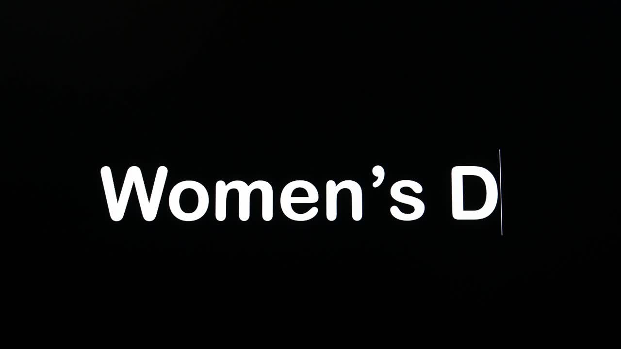 Text written on black screen with the word Women's Day in white