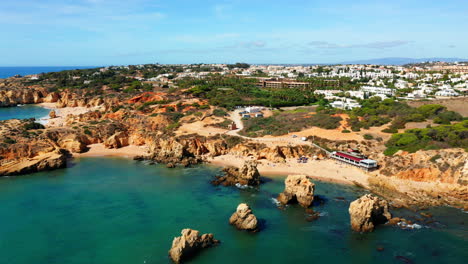 Aerial-pan-shot-of-beautiful-Algarve-Bay-with-sandy-beach-and-tranquil-atlantic-ocean