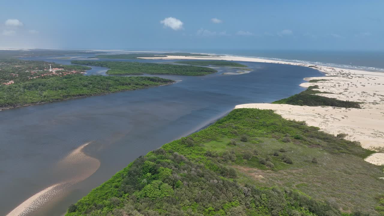 River mouth meeting the sea at Delta do Parnaíba with lush green and sandy shores