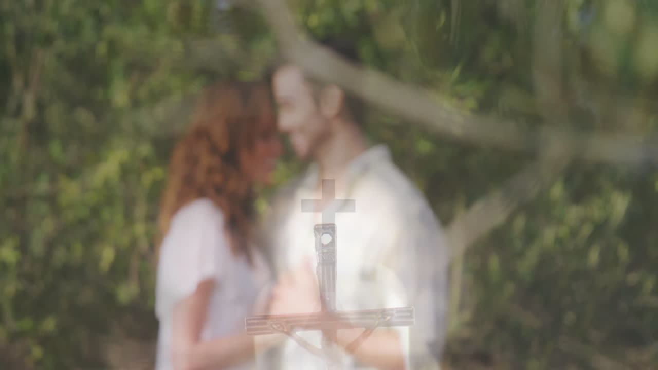 Couple exploring religious education outdoors, engaging with floating crucifix animation overlay