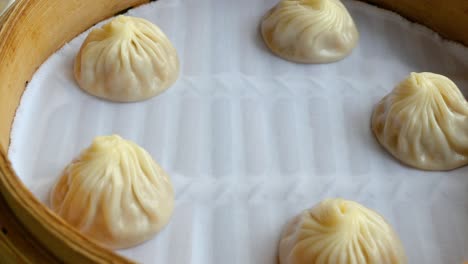 close up circle movement of xiao long bao, streamed pork dumplings chinese food or taiwan food in the restaurant