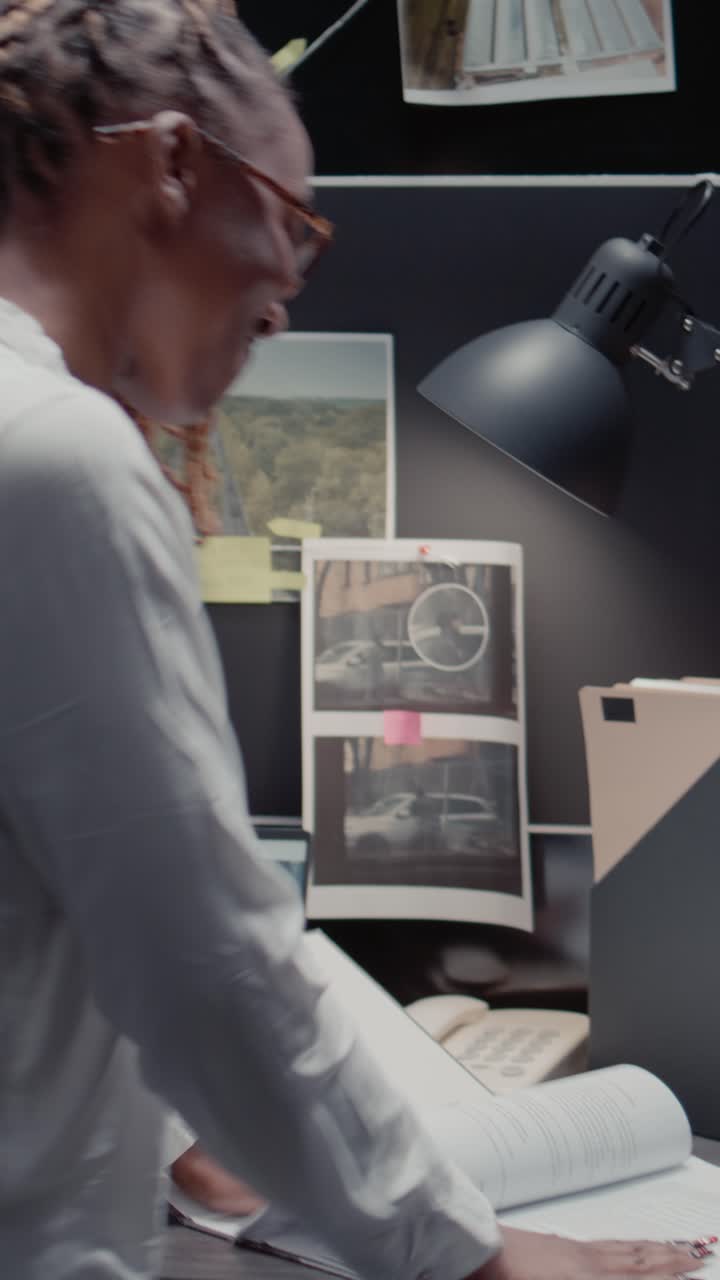 Vertical video: Law agency detective reading criminal records in archive