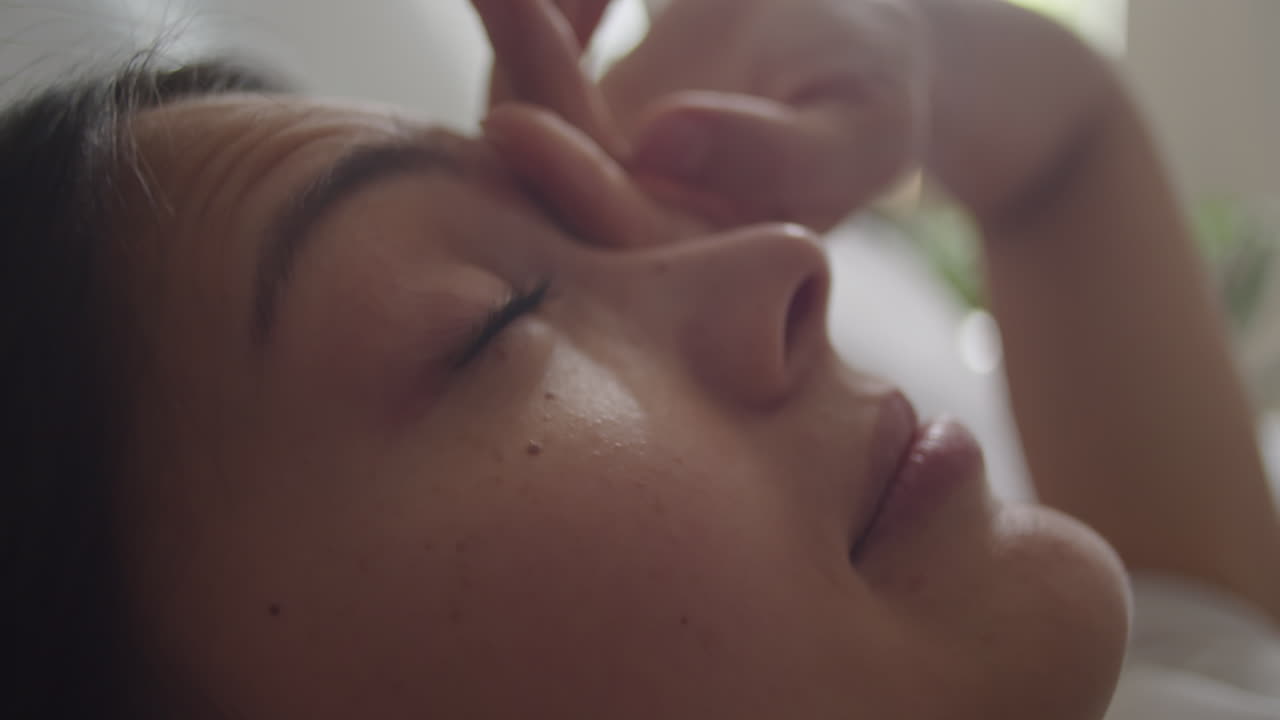 Young Woman Waking Up in Bed in Morning
