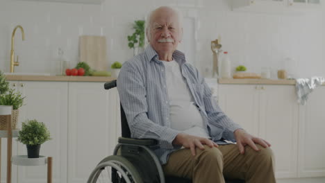 elderly man in wheelchair in kitchen