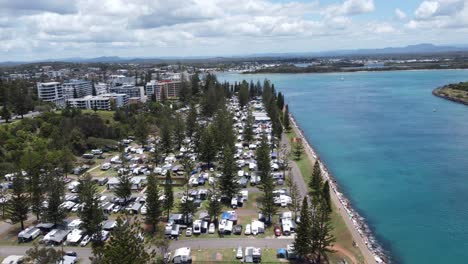 Drone-descending-over-a-caravan-park-near-a-river