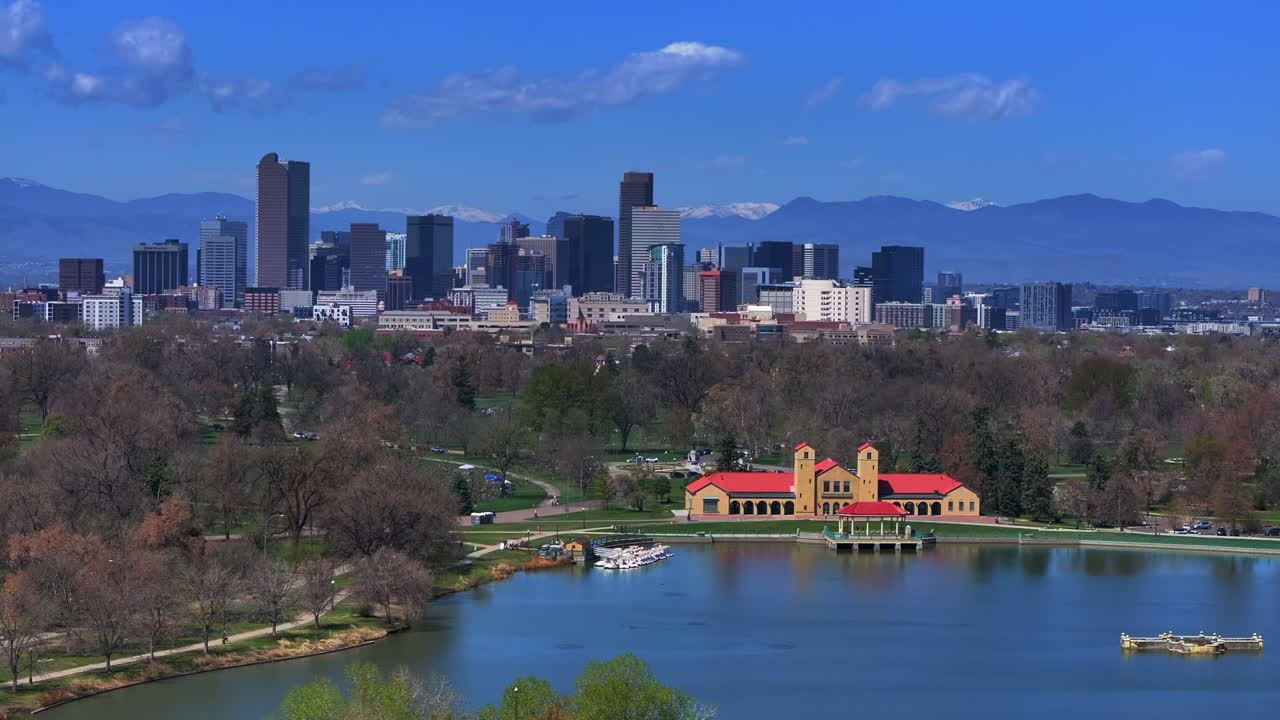 City Park Downtown Denver Colorado aerial drone springtime summer tree wildflower blossom sunny blue sky Ferril Duck Lake bike walking path green grass tall buildings parallax circle right motion