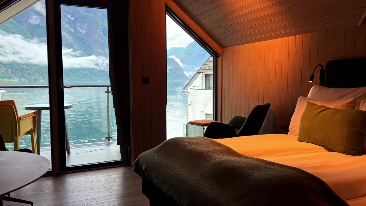 Gemütliches Hotelzimmer mit Balkon und Blick auf Fjord und Berge im malerischen Norwegen
