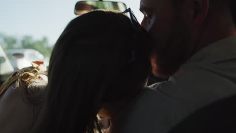 a couple showing affection while driving
