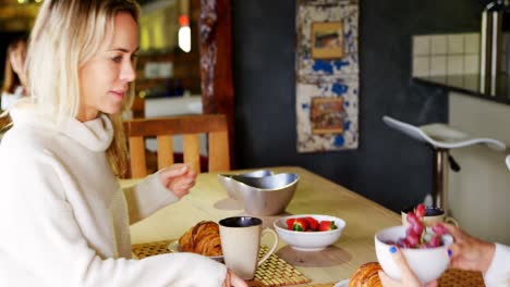 lesbian couple having breakfast in kitchen 4k