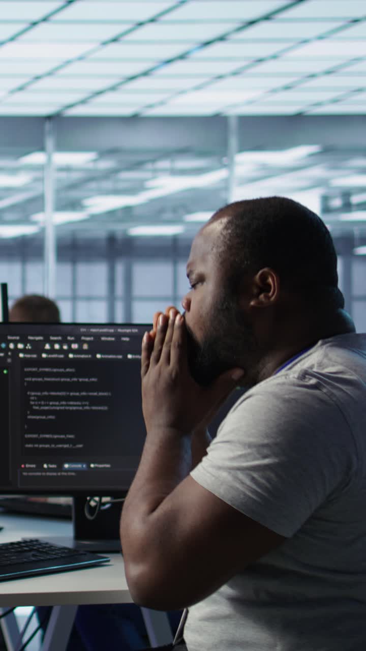 African American Programmer Experiencing Stress While Coding in Office