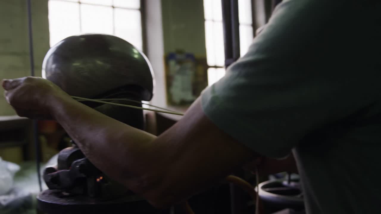 Mixed race man working at a hat factory