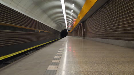 deserted metro station platform during covid-19 virus pandemic, empty platform, low angle slow motion