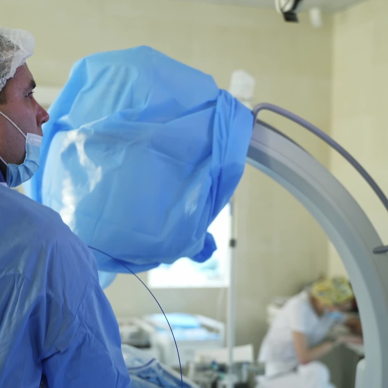 Medical team in the operating room. Doctor perform a surgery and look at the screen of a monitor on operative process. Laparoscopic surgery