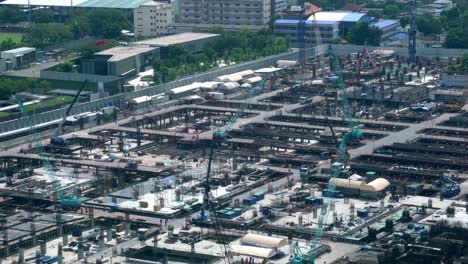 large construction site with heavy construction machinery in metropolis