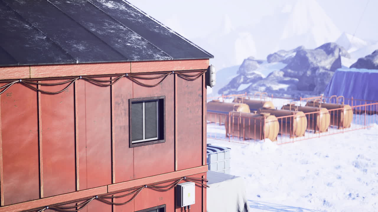 edificio rojo cerca de tanques de almacenamiento en el paisaje nevado durante el día