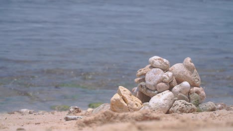 close up focused pile of coral rocks with blurred sea waves