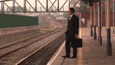 man waiting at a train station